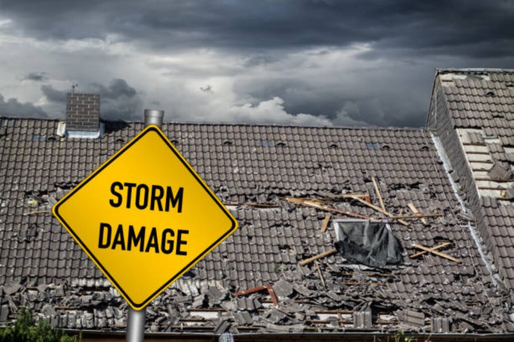 A yellow sign is in front of the roof of a building.